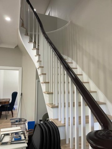 A picture of curved handrail and stair